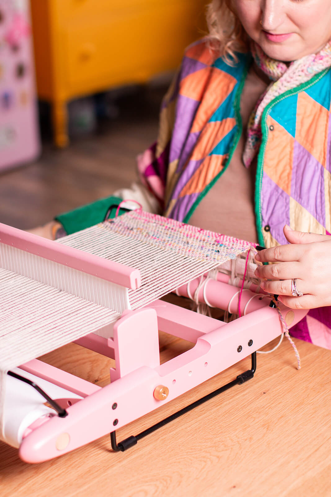 Bryanne weaving on a pink Kromski rigid heddle loom.